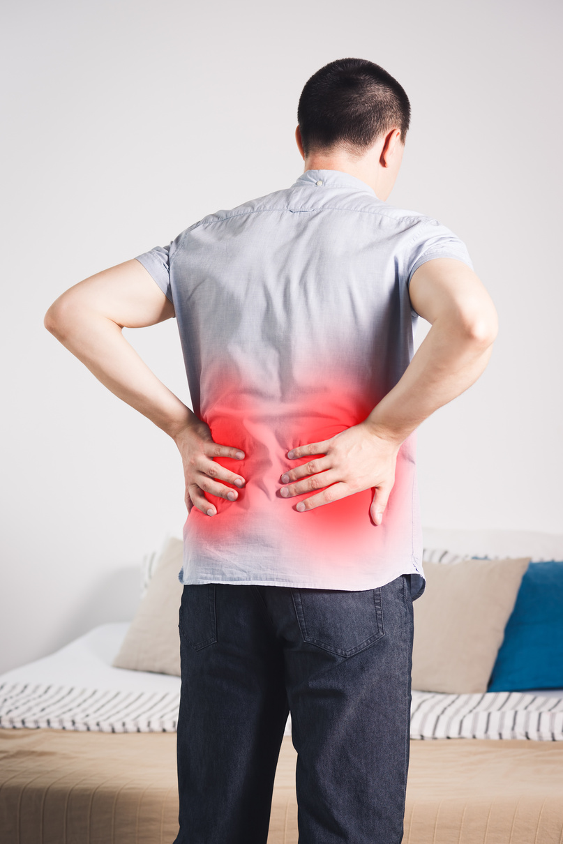 Back pain, kidney inflammation, man suffering from backache at home
